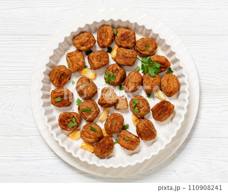 baked meatballs in white baking dish, top view baked meatballs in white baking dish, top view 110908241