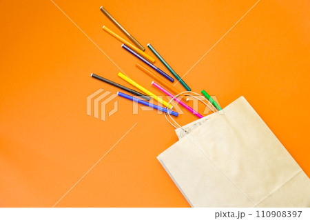Top view brown paper shopping bag on colourful background, Mock-up of blank brown paper shopping bag and copy space. Flat lay. 110908397