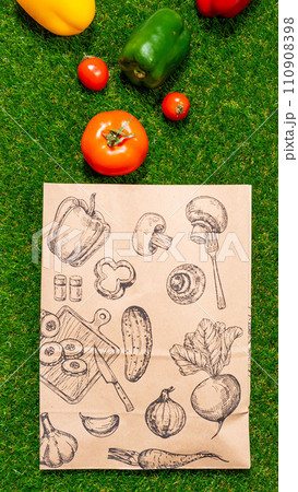 a paper bag lies on the green grass with fruits and vegetables around, moss, mock up a paper bag lies on the green grass with fruits and vegetables around, moss, mock up 110908398