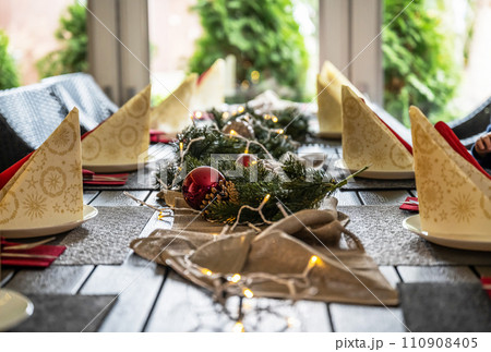 Festive dinner table setting decoration for christmas with Paper, lights 110908405