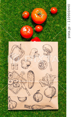a paper bag lies on the green grass with fruits and vegetables around, moss, mock up a paper bag lies on the green grass with fruits and vegetables around, moss, mock up 110908440