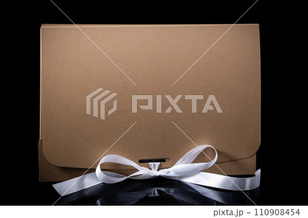 Man gift concept. gift box with luxury bow on dark background. Horizontal with copy space. Man gift concept. gift box with luxury bow on dark background. Horizontal with copy space. 110908454