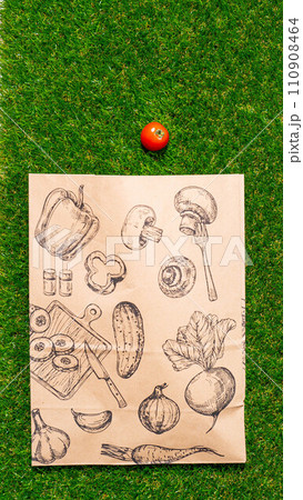 a paper bag lies on the green grass with fruits and vegetables around, moss, mock up a paper bag lies on the green grass with fruits and vegetables around, moss, mock up 110908464