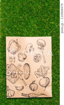 a paper bag lies on the green grass with fruits and vegetables around, moss, mock up a paper bag lies on the green grass with fruits and vegetables around, moss, mock up 110908479