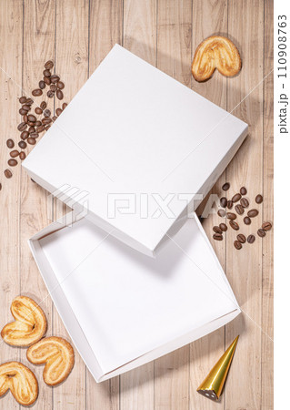 White box mockup between different sweets on the table and figures 110908763