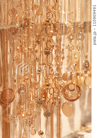 blurred gold jewelry necklace chains for background, panel gold shop jewelry store for seller products and gold showcase 110909491