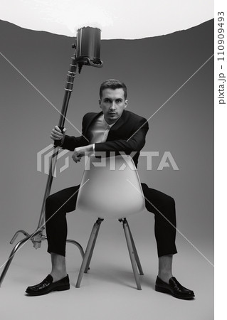 elegant model man in black suit in photostudio. black and white elegant model man in black suit in photostudio. black and white 110909493