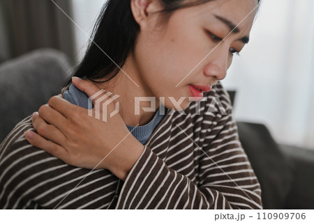 Upset young woman touching neck, suffering from pain and strain. Healthcare and problem concept Upset young woman touching neck, suffering from pain and strain. Healthcare and problem concept 110909706