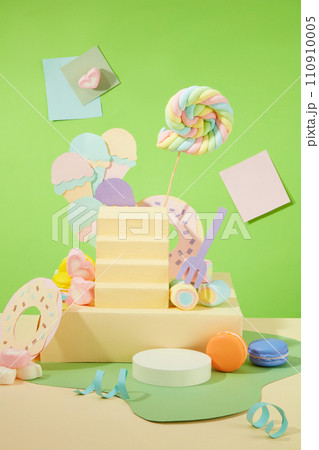 An attractive layout with a birthday theme on a green background. Macarons, marshmallows and cute decorations are displayed around the yellow platform. An attractive layout with a birthday theme on a green background. Macarons, marshmallows and cute decorations are displayed around the yellow platform. 110910005