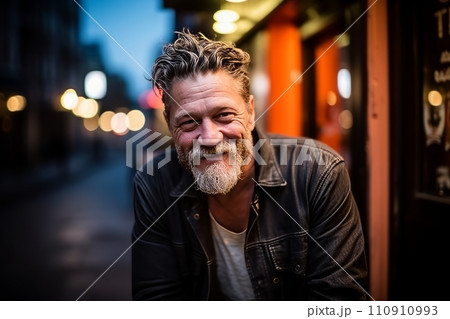 Portrait of a handsome middle aged man with a beard in the city at night. Portrait of a handsome middle aged man with a beard in the city at night. 110910993