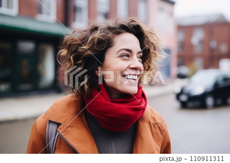 Portrait of a beautiful young woman with curly hair and red scarf. 110911311