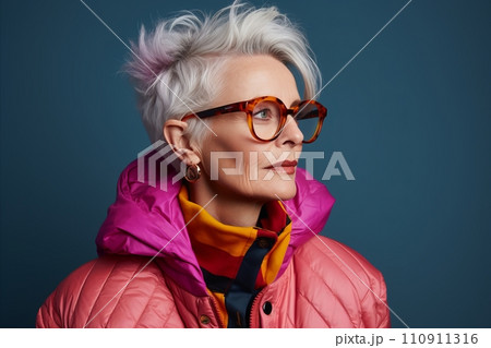 Portrait of a beautiful senior woman in pink jacket and glasses 110911316