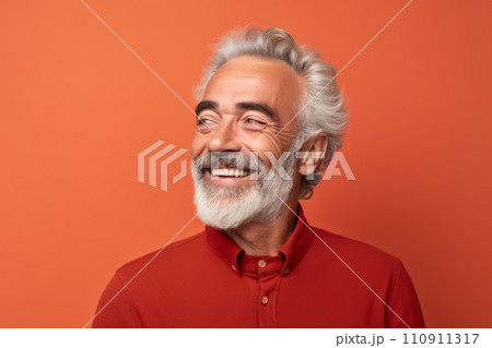 Portrait of happy senior man in red shirt. Isolated over orange background 110911317