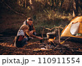 Man and boy tourists autumn time leisure, vacation hiking or traveling touristic activity. Family camping, father and little son relax in forest camp. 110911554
