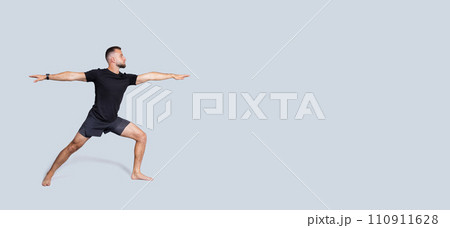 Focused calm handsome strong millennial european man with beard in sportswear practice yoga Focused calm handsome strong millennial european man with beard in sportswear practice yoga 110911628