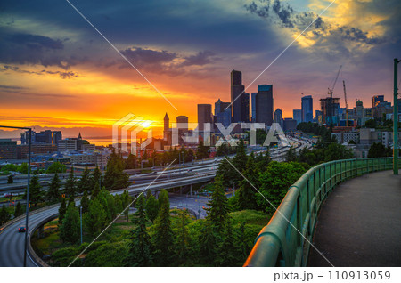 Dramatic sunset over Seattle skyline with highway in foreground 110913059