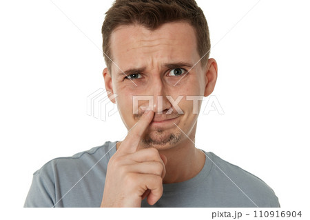 man is picking his nose isolated on white background. 110916904