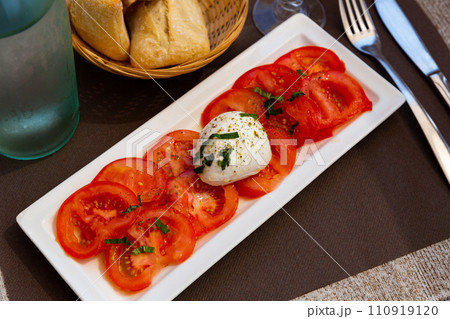 Traditional dish of Italian cuisine tomatoes and mozzarella cheese Traditional dish of Italian cuisine tomatoes and mozzarella cheese 110919120