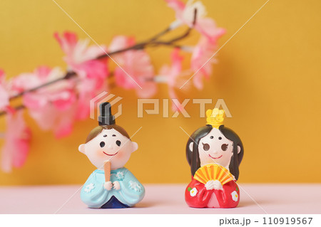 ひな人形のおもちゃと桃の花を金色の背景で ひな人形のおもちゃと桃の花を金色の背景で 110919567