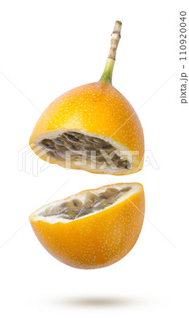 Granadilla broken in half flies close-up on a white background. Isolated Granadilla broken in half flies close-up on a white background. Isolated 110920040