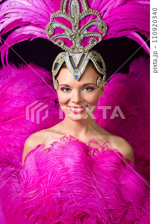 Beautiful Girl in carnival costume with pink feathers. 110920340