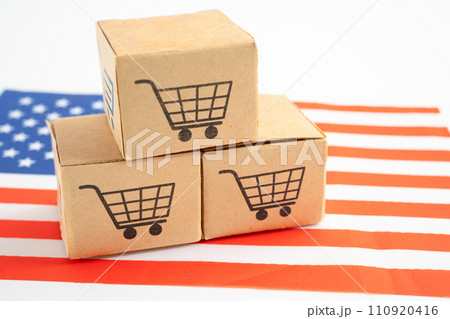 Box with shopping online cart logo and USA America flag, Import Export Shopping online or commerce finance delivery service store product trade, supplier. Box with shopping online cart logo and USA America flag, Import Export Shopping online or commerce finance delivery service store product trade, supplier. 110920416