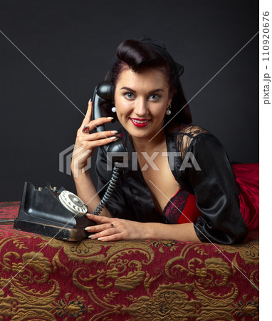 Woman in lingerie with old phone. 110920676