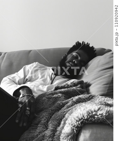 AI-generated content. Frustrated young Afro American man in glasses lying in bed with scarf around his neck having sleepless night because of fever, suffering from virus or infection, waiting for 110920942