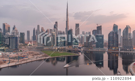 Aerial view to Dubai Business Bay and Downtown with the various skyscrapers and towers night to day timelapse 110922894