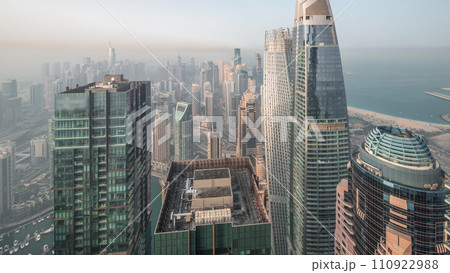 Skyline panoramic view of Dubai Marina showing canal surrounded by skyscrapers along shoreline night to day timelapse. DUBAI, UAE Skyline panoramic view of Dubai Marina showing canal surrounded by skyscrapers along shoreline night to day timelapse. DUBAI, UAE 110922988