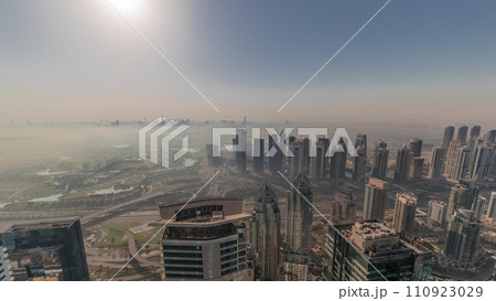 Panorama of Dubai Marina with JLT skyscrapers and golf course during sunrise timelapse, Dubai, United Arab Emirates. 110923029