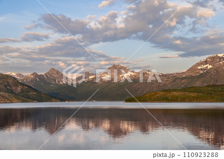 Golden hour over snowy Agskardet peaks and fjord Golden hour over snowy Agskardet peaks and fjord 110923288
