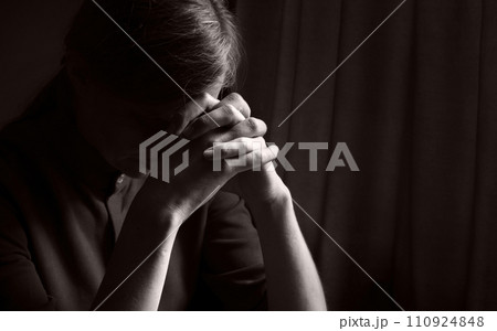 Praying woman at the window 110924848