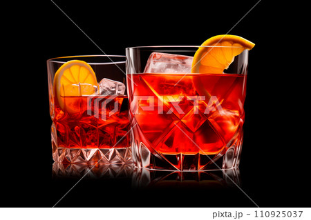 Set of Negroni in a crystal-cut rocks glass isolated on black backdrop Set of Negroni in a crystal-cut rocks glass isolated on black backdrop 110925037