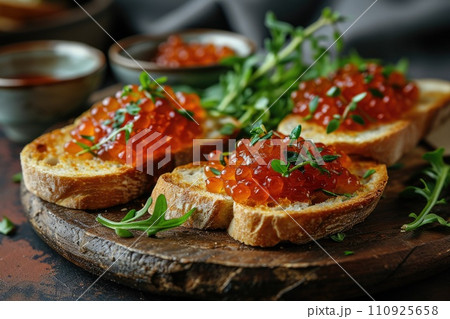 Sandwich with red caviar on a wooden table: a treat for connoisseurs of taste 110925658