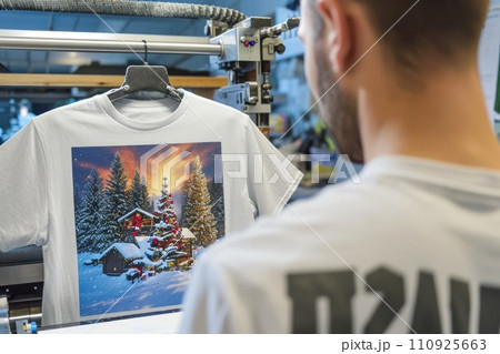 Man creating a unique design on a T-shirt by printing 110925663
