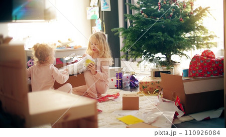 Kids unbox and unwrap Christmas gifts at home Kids unbox and unwrap Christmas gifts at home 110926084