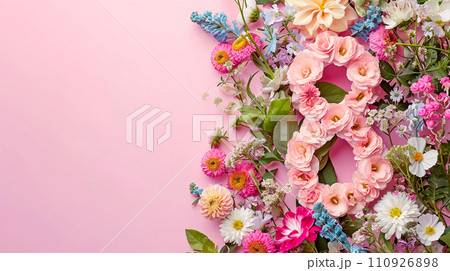 Floral arrangement with number eight made from lisianthium flowers on a pink background.  110926898