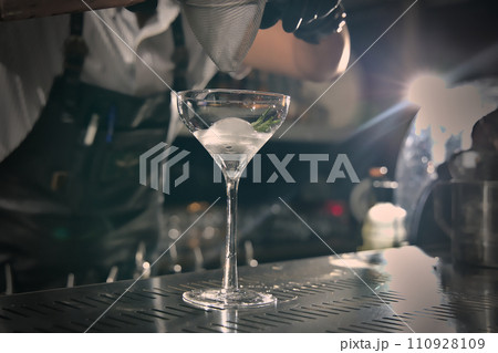 Close-up view of a cocktail glass on the bar counter. Close-up view of a cocktail glass on the bar counter. 110928109