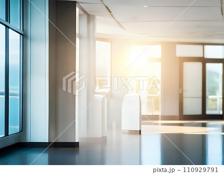 Light blurred background. The hall of an office or medical institution with panoramic windows and a perspective. 110929791