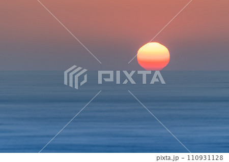 Sun setting over blue ocean Sun setting over blue ocean 110931128