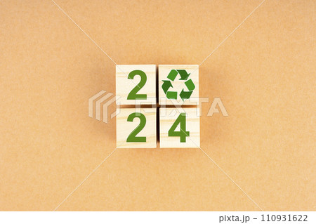 2024 Numbers and recycle symbol on wooden cube. 110931622