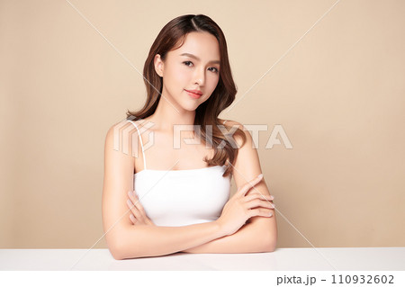 Beautiful young asian woman with clean fresh skin on beige background, Face care, Facial treatment, Cosmetology, beauty and spa, Asian women portrait. 110932602