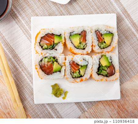 Set of uramaki rolls with salmon, avoado and cucumber closeup Set of uramaki rolls with salmon, avoado and cucumber closeup 110936418