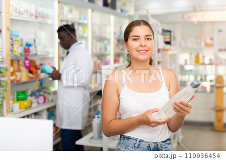 Young lady choosing haircare products 110936454