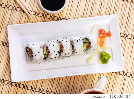 Set of uramaki rolls with salmon, avoado and cucumber closeup Set of uramaki rolls with salmon, avoado and cucumber closeup 110936484