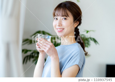 リビングでコップを持つミドル女性 リビングでコップを持つミドル女性 110937545