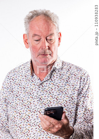 Senior Man Engrossed in Technology 110938283
