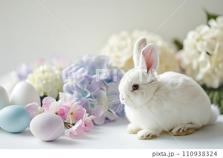 White Bunny surrounded by pastel colored eggs and blooming hydrangeas White Bunny surrounded by pastel colored eggs and blooming hydrangeas 110938324