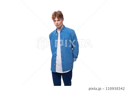 young smart european man with copper hair wears a denim shirt over a t-shirt 110938342